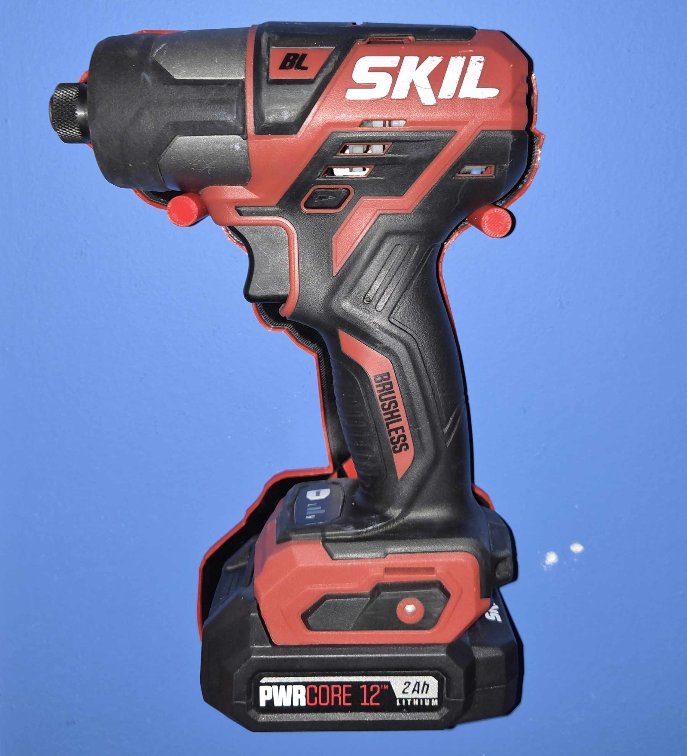 Front view of a SKIL PWRCore 12V impact driver stored in the holder