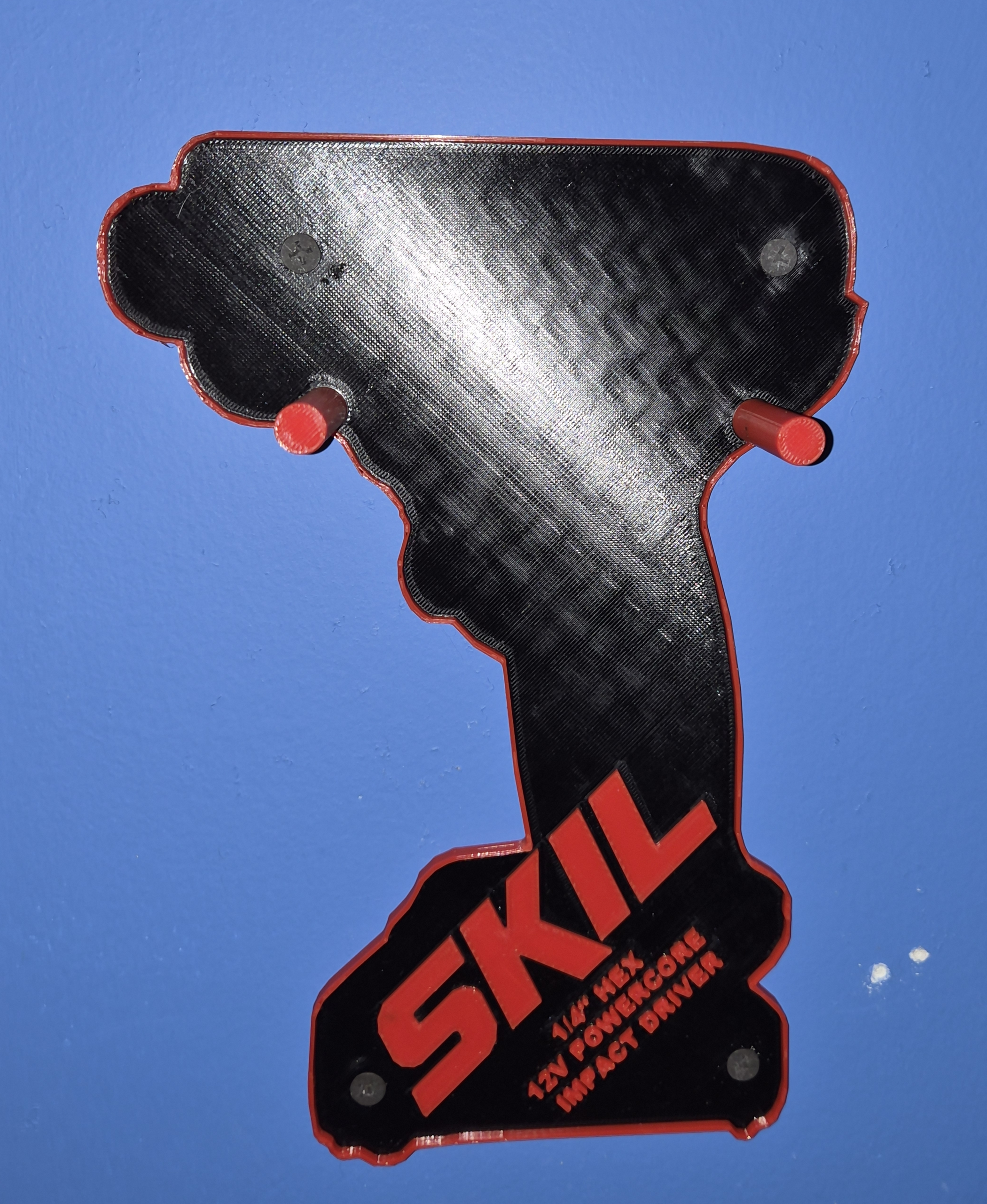 Empty SKIL PWRCore 12V tool holder mounted on a blue wall