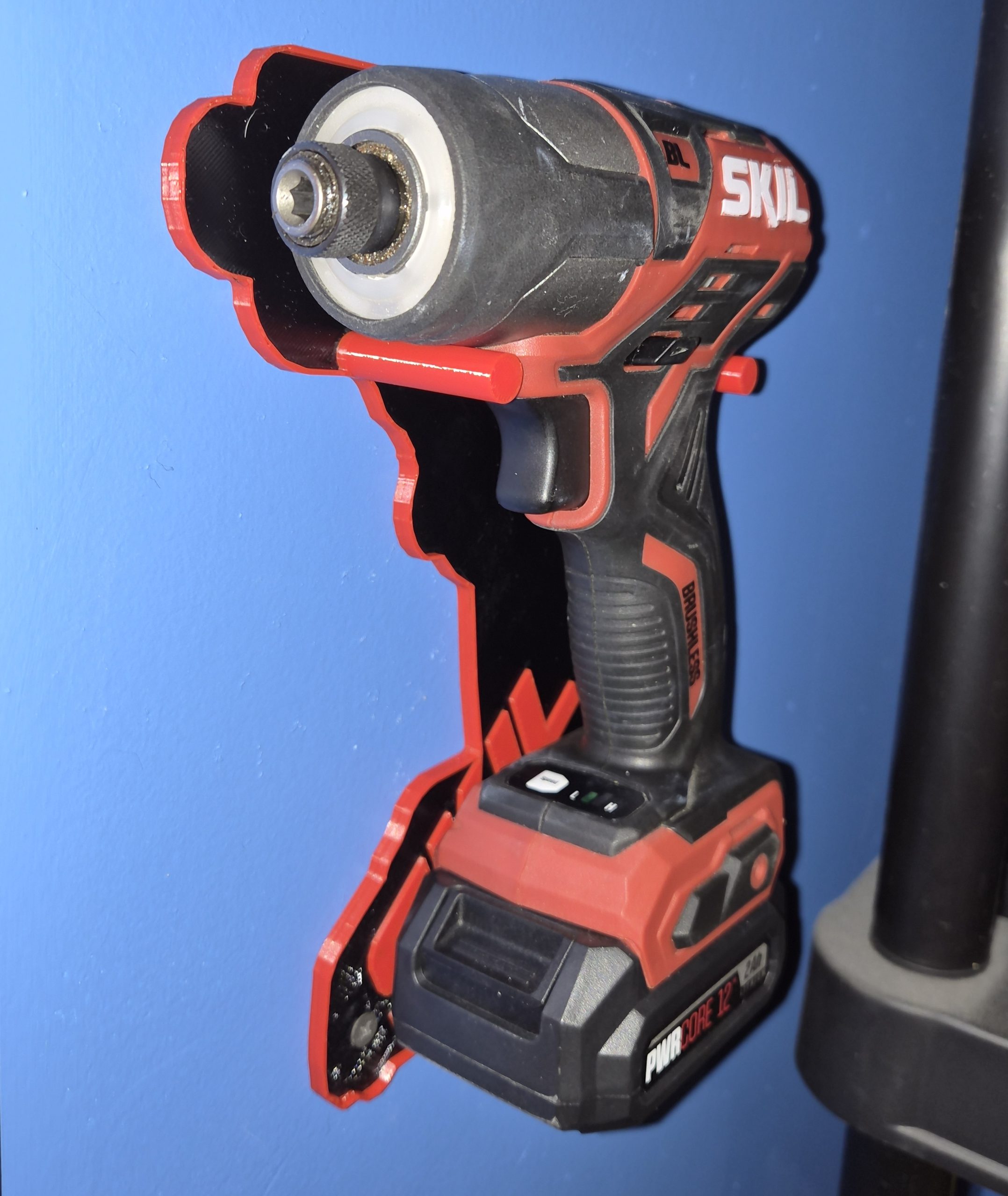 Angled view of a SKIL PWRCore 12V impact driver in the holder